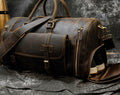 Dark Brown leather travel bag with shoulder strap, angled view
