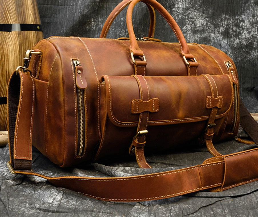 Red Brown leather travel bag with shoulder strap, angled view