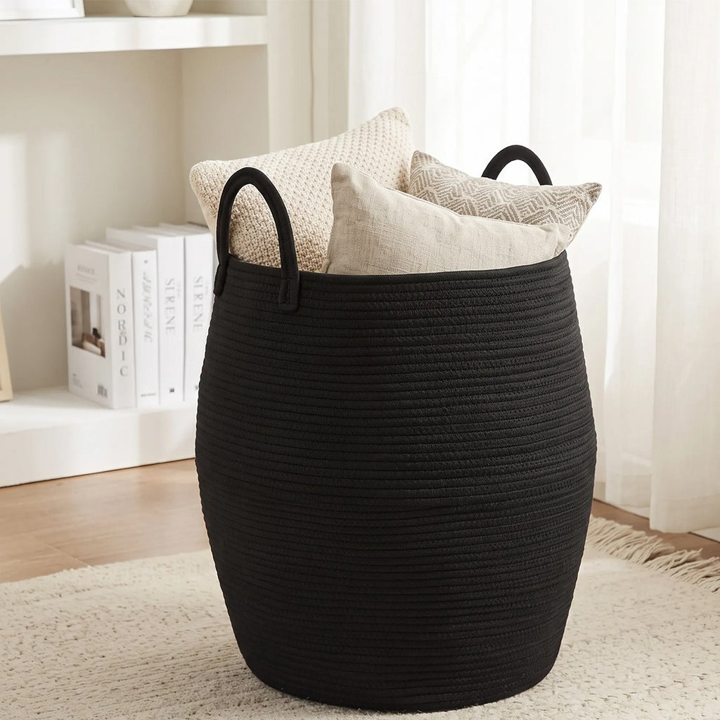 Black rope basket holding cushions in a bright living room