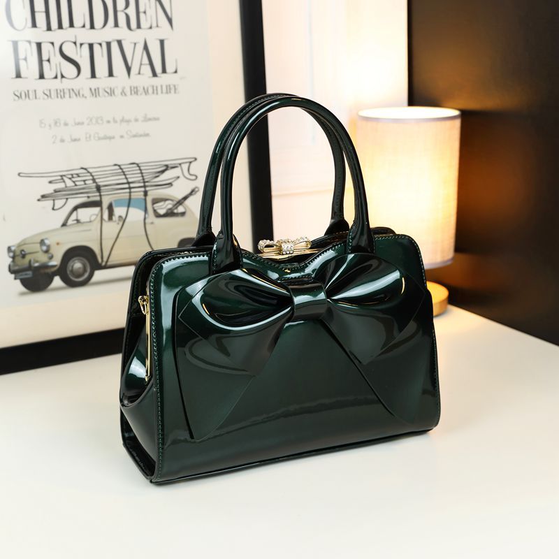 Structured handbag showing hook clasp and top handle