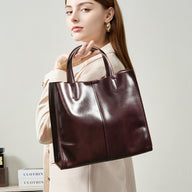 Woman carrying the soft cowhide leather handbag in Wine Coffee on her arm