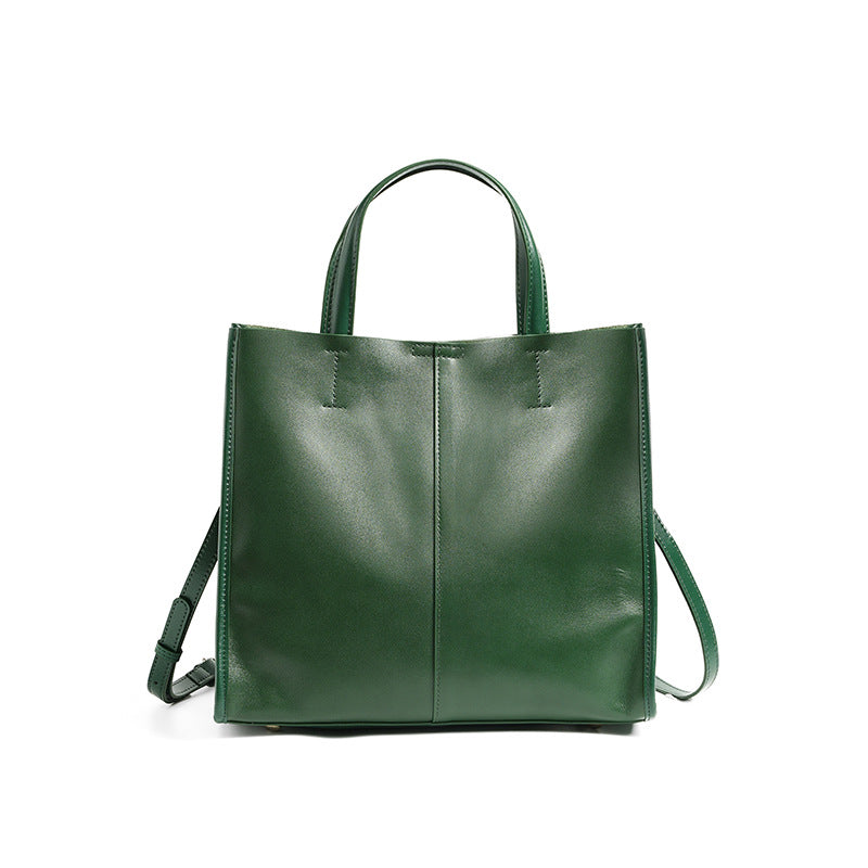 Soft cowhide leather handbag in Green, front view with shoulder strap