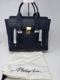3.1 Phillip Lim Pashli medium satchel in navy pebbled leather, front view with the 3.1 Phillip Lim dust bag