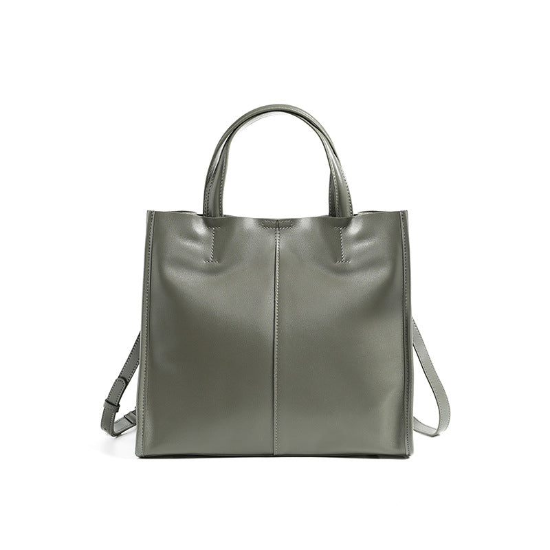 Soft cowhide leather handbag in Grey, front view with shoulder strap