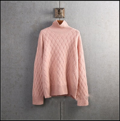 Pink lattice cable turtleneck jumper on hanger