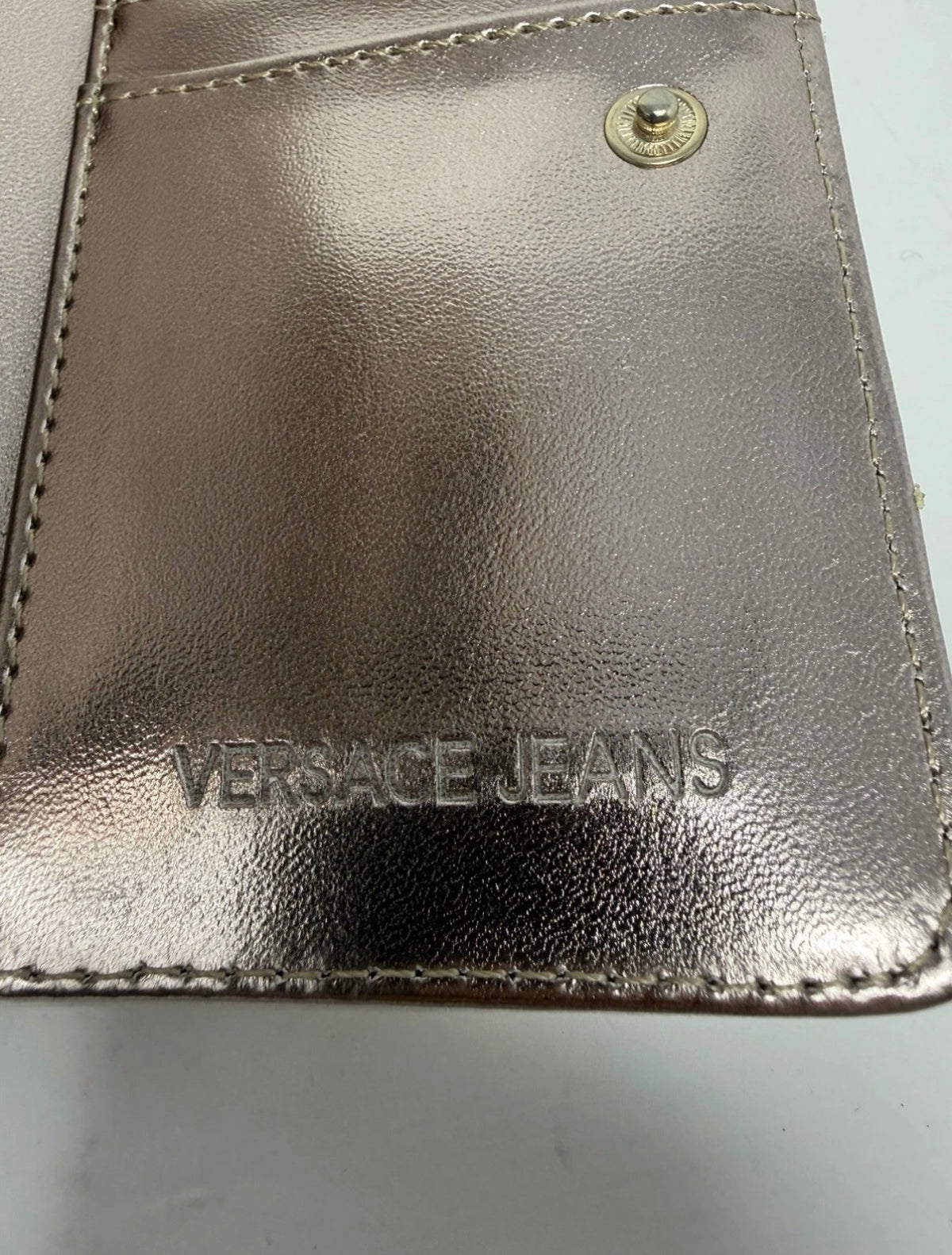 Versace Jeans white nappa leather purse with VJ logo, showcasing the sleek design and detailed craftsmanship.