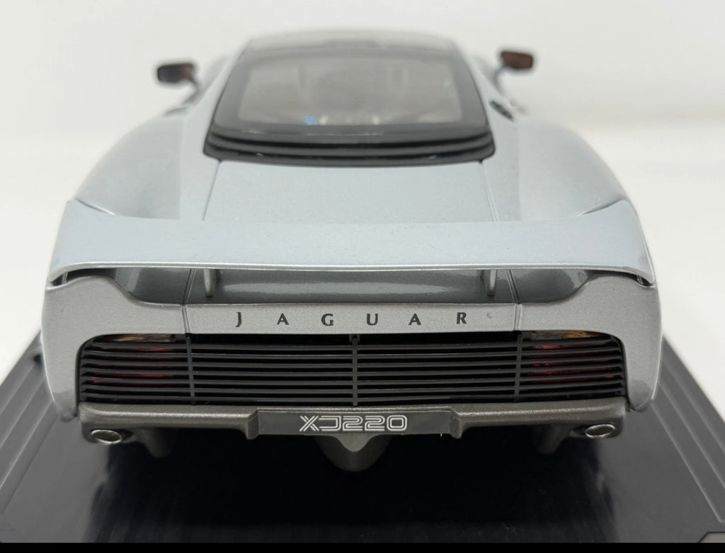 Silver Maisto Jaguar XJ220 1992 diecast model car with detailed exterior, displayed on a plain background.