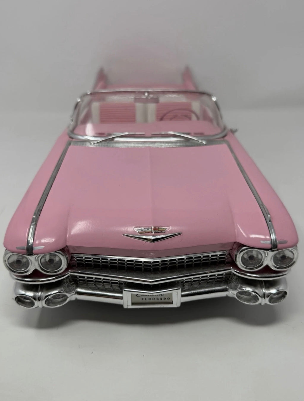 Pink Maisto 1:12 diecast model of 1959 Cadillac Eldorado Biarritz convertible, detailed collectible toy car.