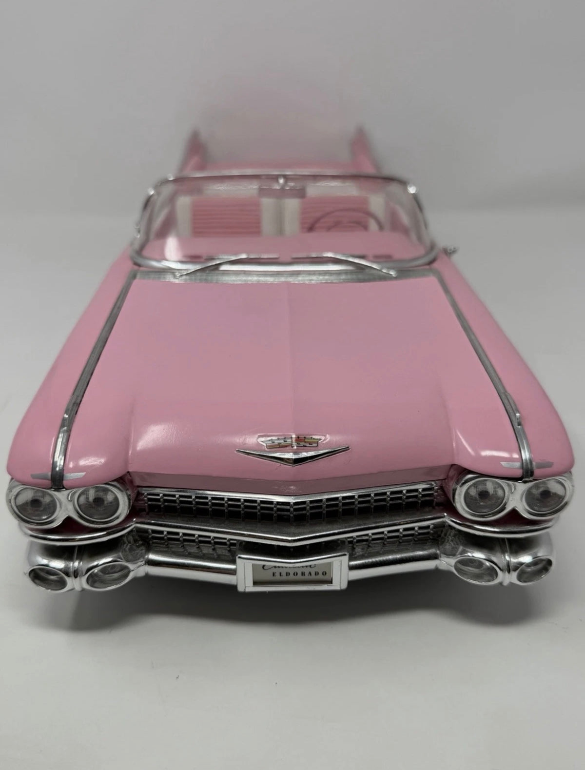 Pink Maisto 1:12 diecast model of 1959 Cadillac Eldorado Biarritz convertible, detailed collectible toy car.
