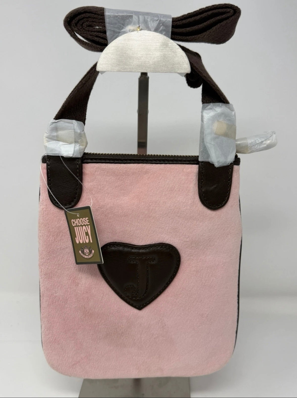Juicy Couture pink velour crest crossbody bag with adjustable strap and gold-tone hardware, new with tags.