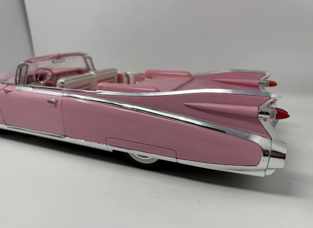Pink Maisto 1959 Cadillac Eldorado Biarritz diecast convertible model, detailed toy car in a collectible display.