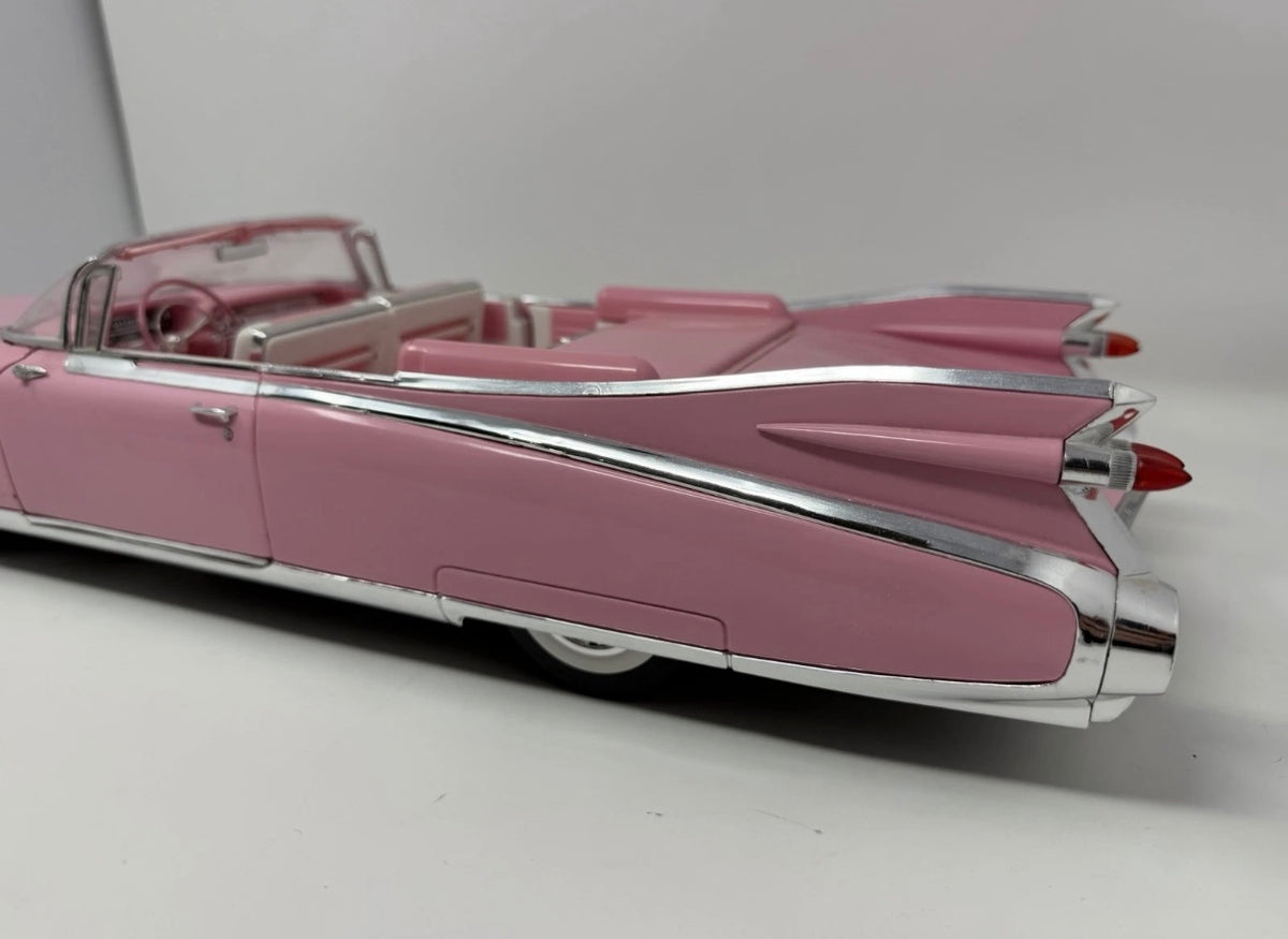 Pink Maisto 1959 Cadillac Eldorado Biarritz diecast convertible model, detailed toy car in a collectible display.