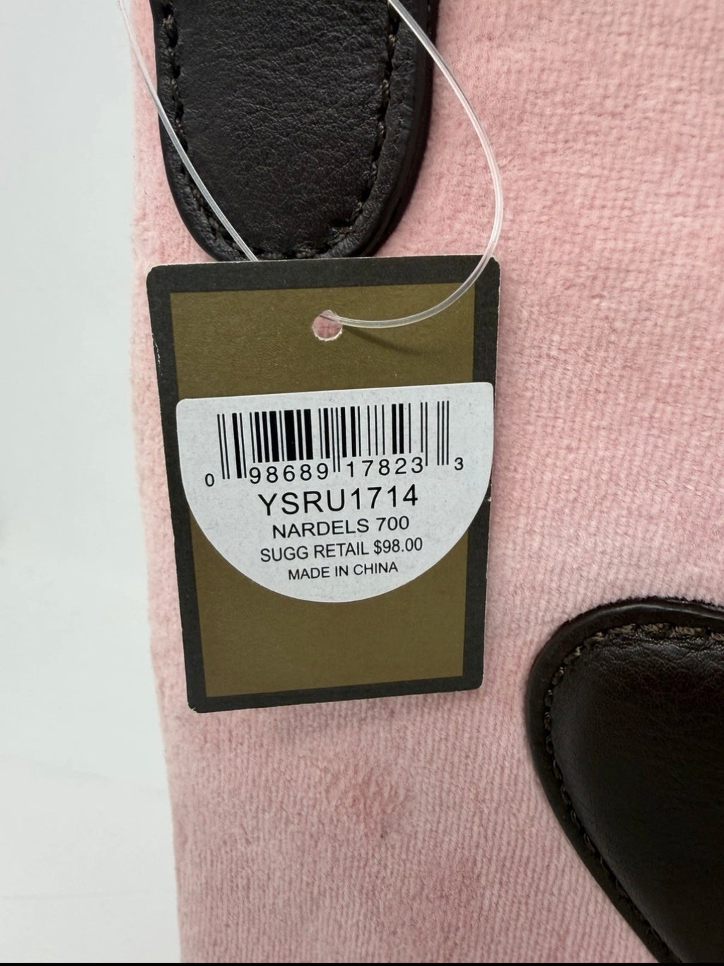 Juicy Couture pink velour crest crossbody bag with adjustable strap, featuring a prominent logo and gold-tone accents.
