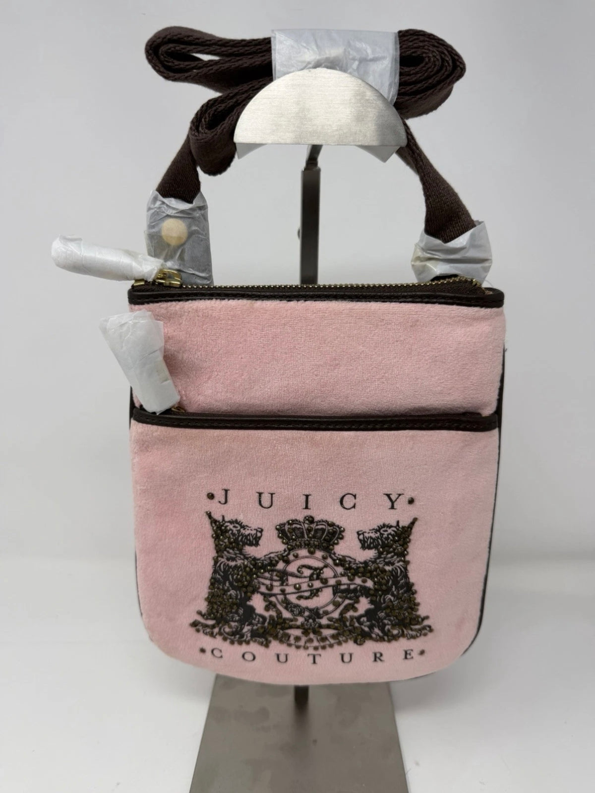 Juicy Couture pink velour crest crossbody bag with adjustable strap and gold-tone hardware, new with tags.