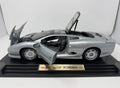 Maisto Jaguar XJ220 1992 diecast model car in silver, detailed 1:12 scale with original box, perfect for collectors and enthusiasts.