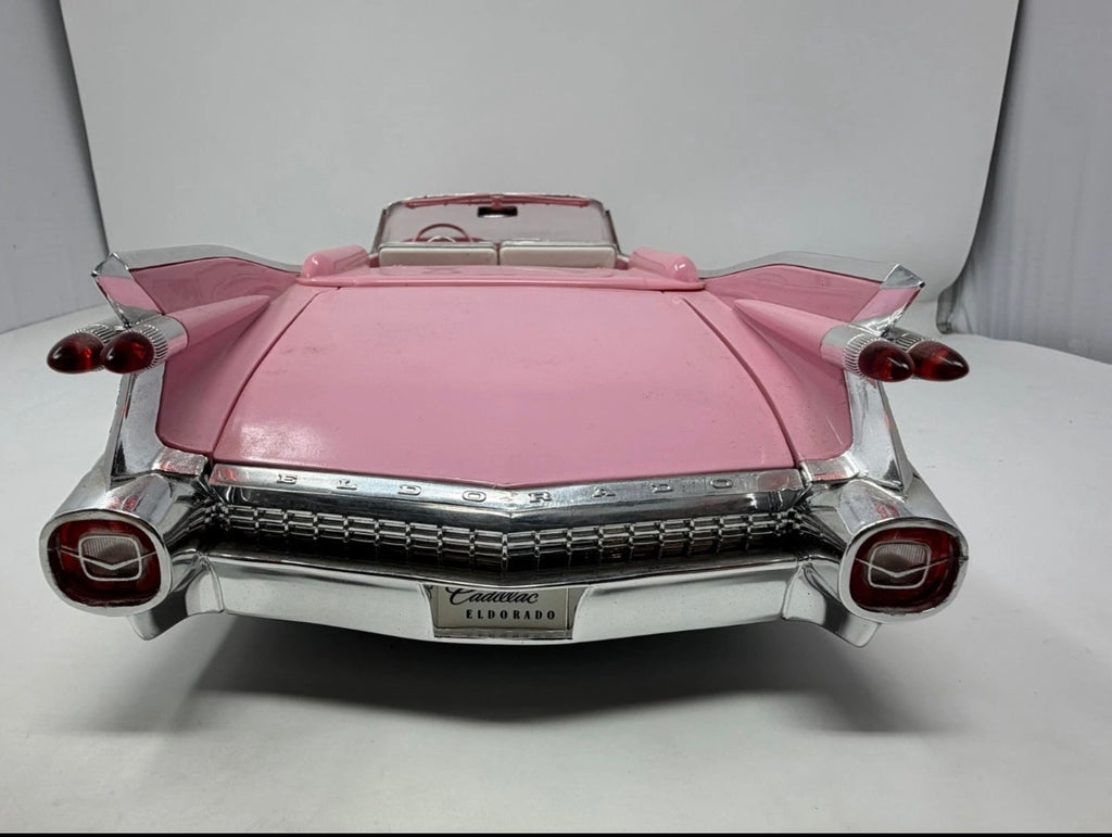 Pink Maisto 1959 Cadillac Eldorado Biarritz diecast convertible model, detailed toy car with shiny finish and open convertible top.