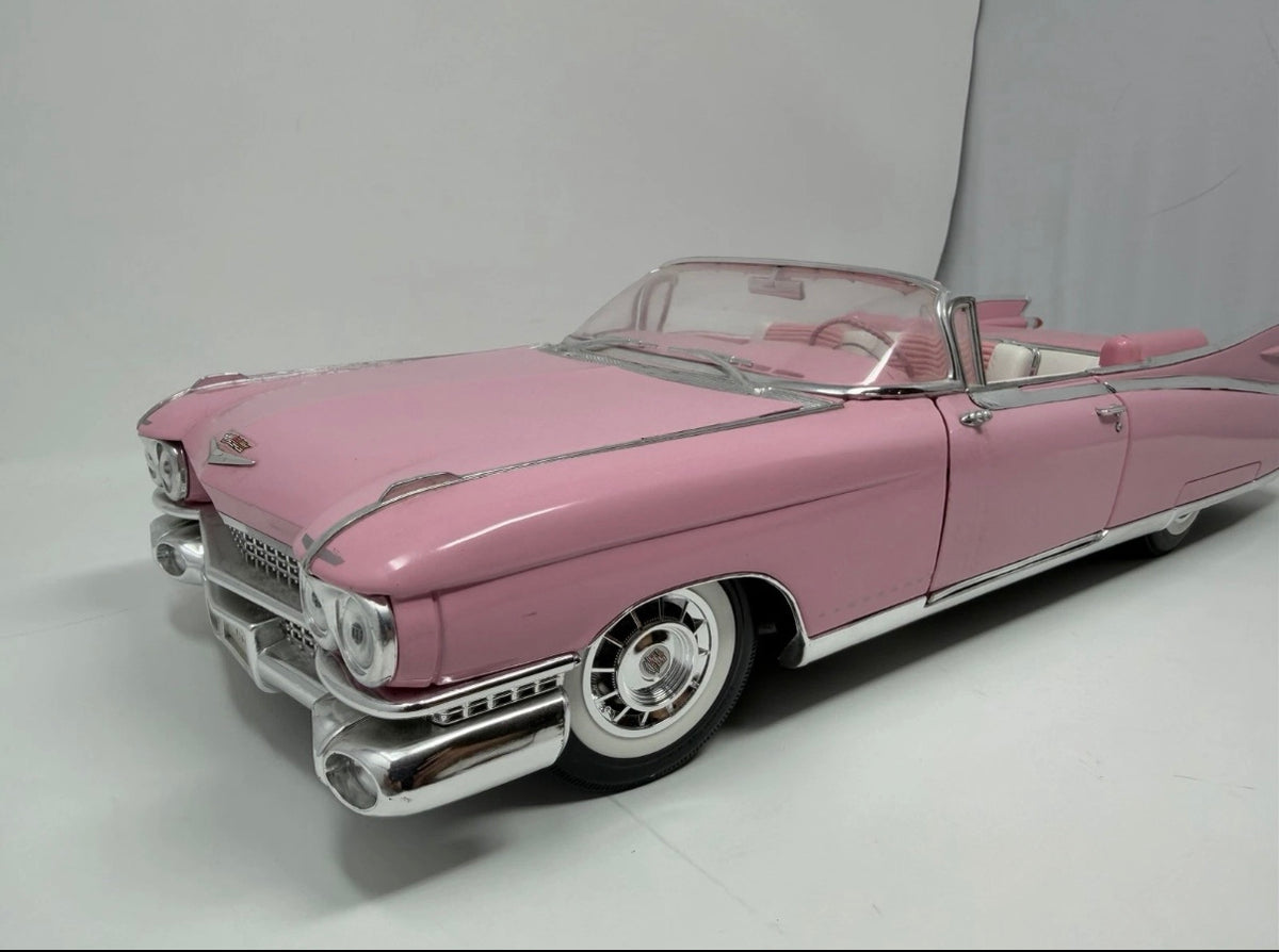 Pink Maisto 1:12 diecast model of 1959 Cadillac Eldorado Biarritz convertible, detailed collectible toy car.