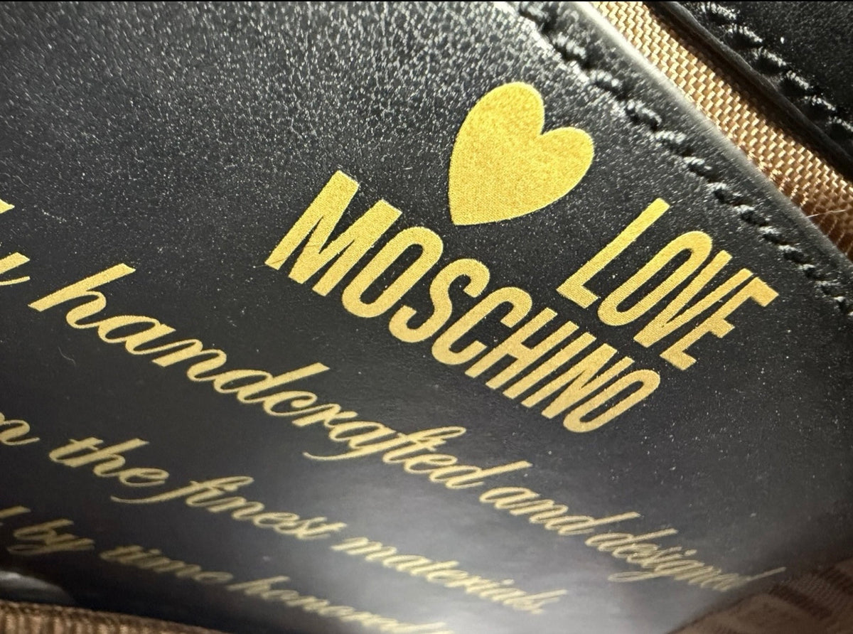 Black Love Moschino shoulder bag with cow appliqué, chain strap, and stylish design, perfect for casual and chic outfits.