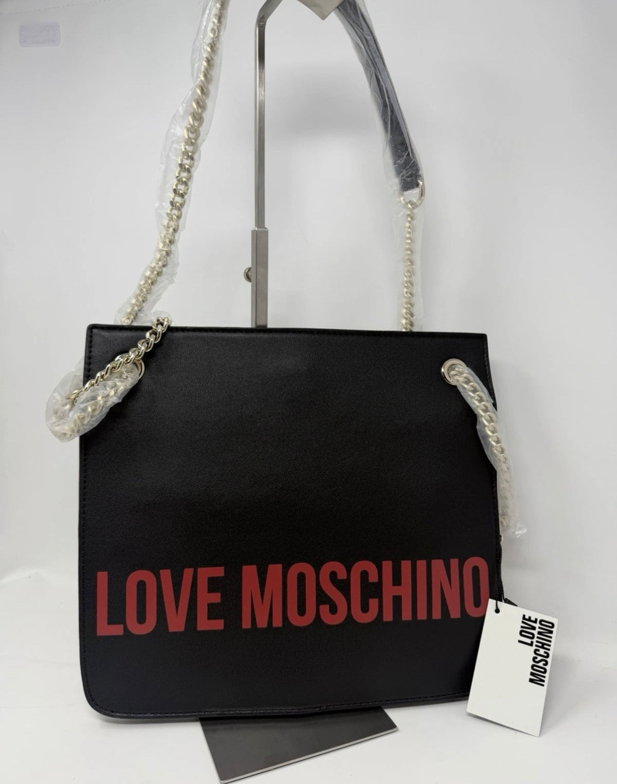 Love Moschino black shoulder bag with cow appliqué and chain strap, stylish designer bag for everyday or special occasions.