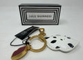 Lulu Guinness lips and leather keyring and bag charm with bold lips design and silver hardware on a neutral background.