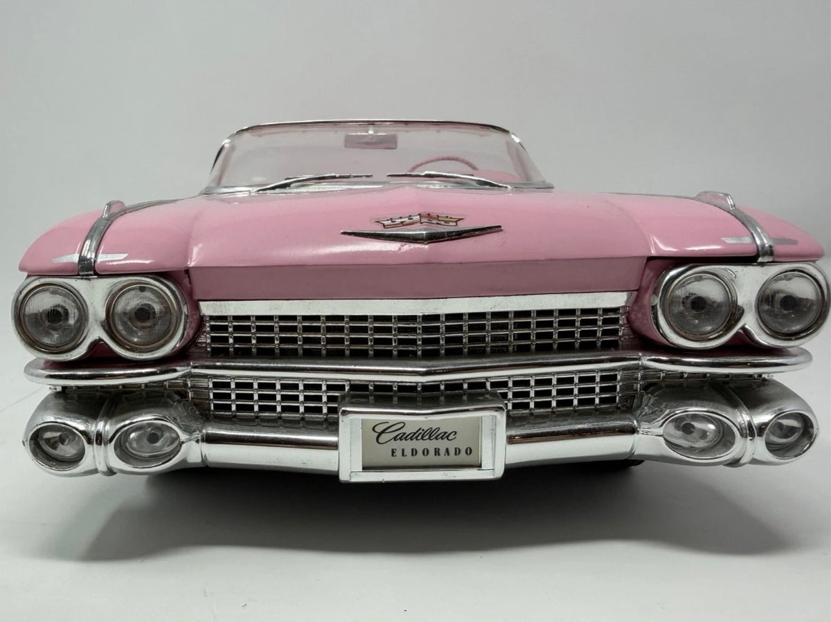 Pink Maisto 1959 Cadillac Eldorado Biarritz diecast convertible model car, detailed scale model in a collectible toy display.