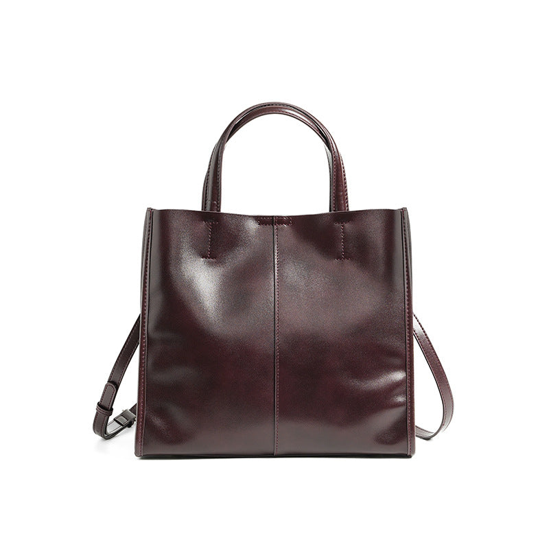 Soft cowhide leather handbag in Wine Coffee, front view with shoulder strap