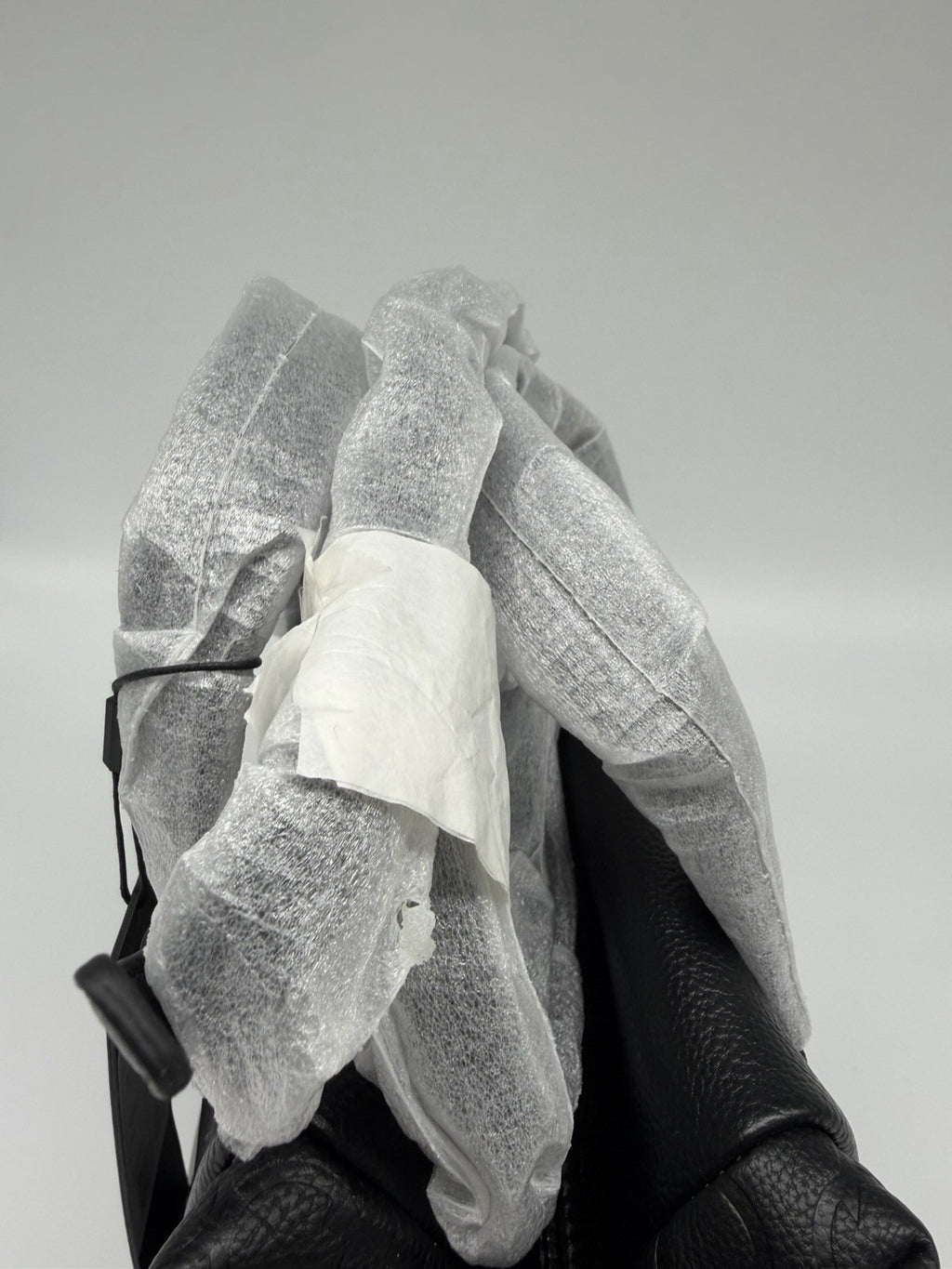 Black Calvin Klein Misha duffle bag with CK monogram, strap, and dust bag, featuring a sleek, spacious design for travel or everyday use.