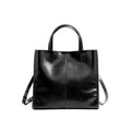 Soft cowhide leather handbag in Black, front view with shoulder strap