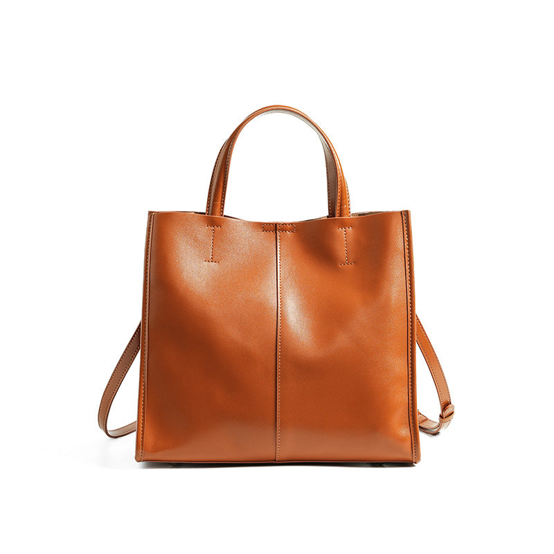 Soft cowhide leather handbag in Sunset Yellow, front view with shoulder strap