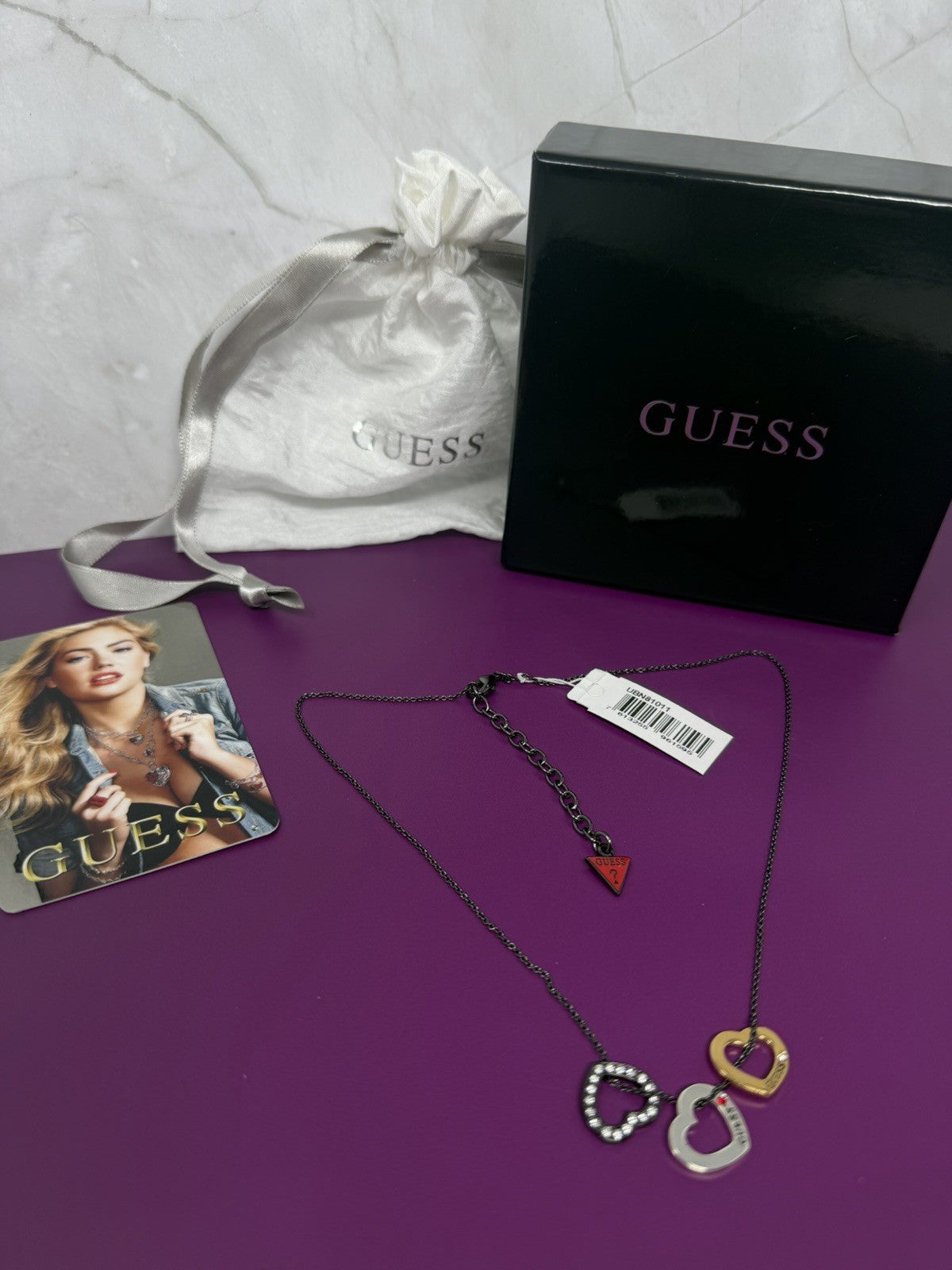 Guess Multi Heart Charm Pendant Necklace from Series VII Spring 2011, featuring multiple heart charms on a silver chain.