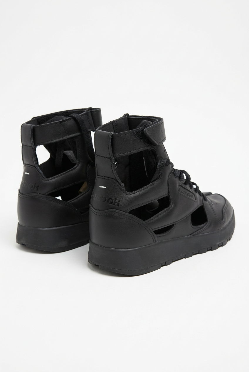 AI-enhanced rear three-quarter view of black Margiela x Reebok Tabi High trainers showing cut-out panels and white heel stitches.