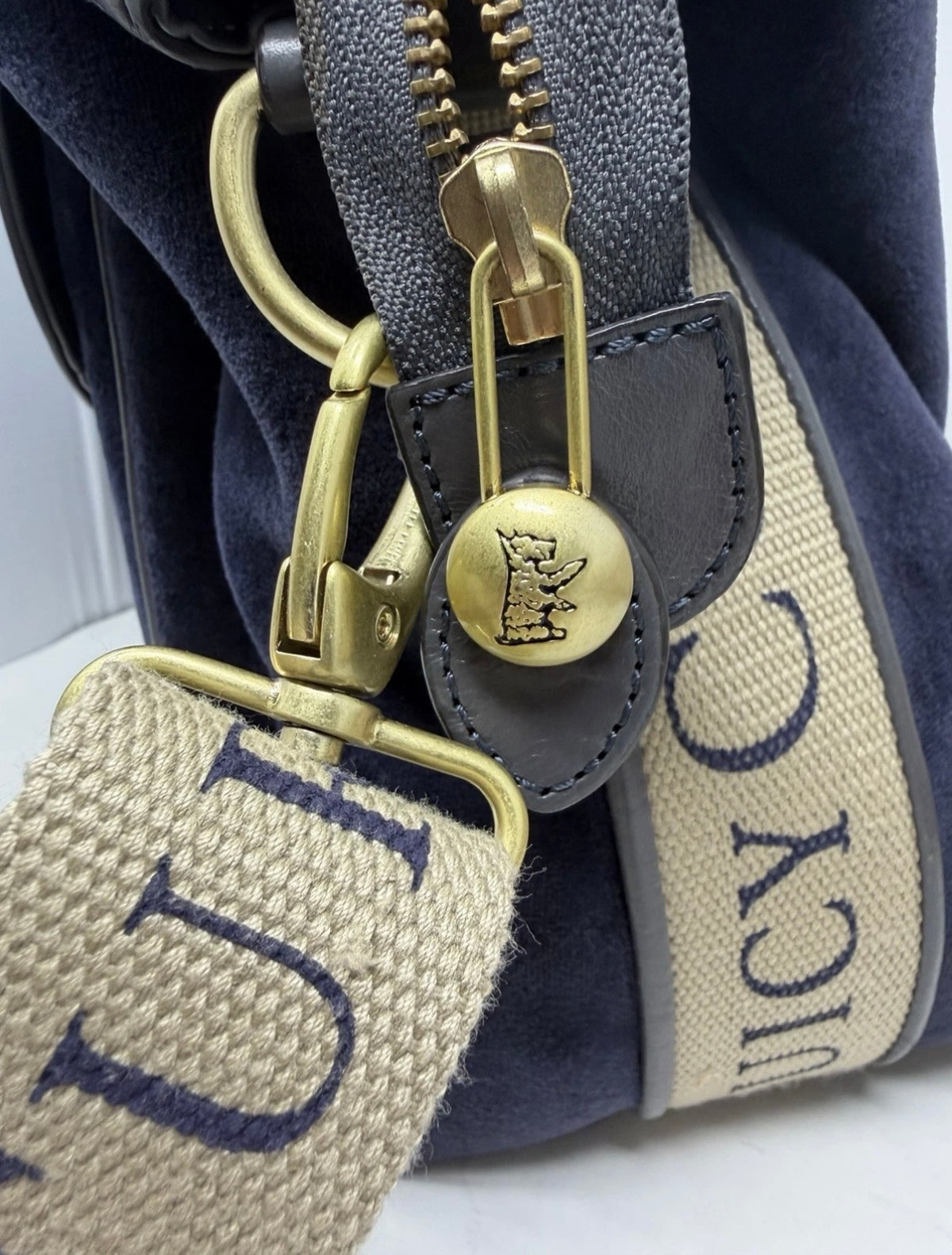 Large navy velour shoulder bag by Juicy Couture with grey leather trim and matching shoulder strap, stylish and spacious.