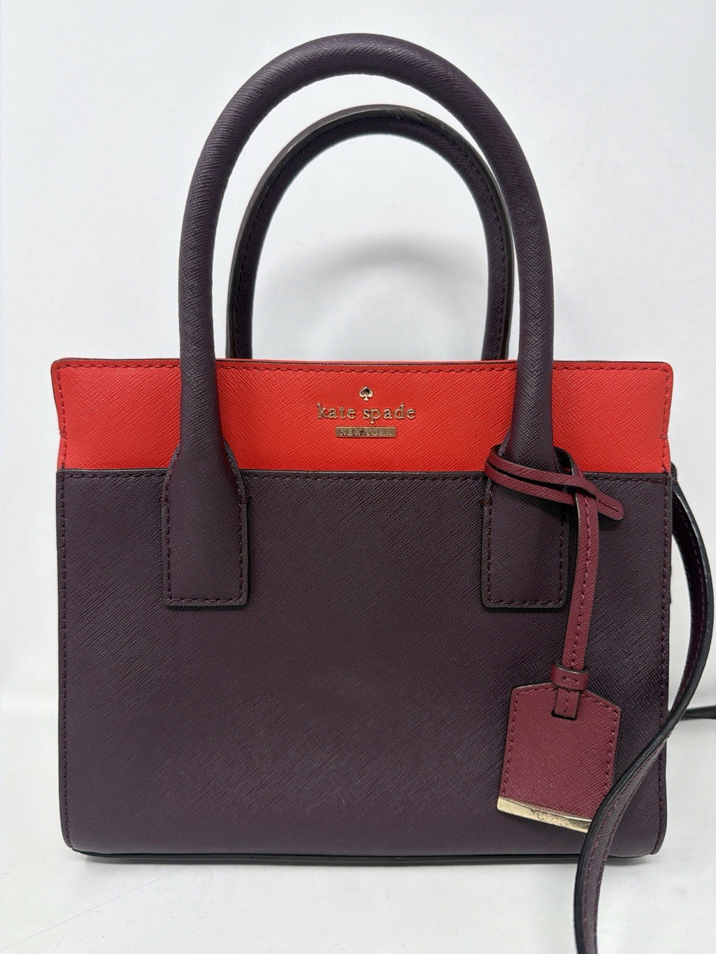 Kate Spade New York Small Cameron Saffiano leather satchel in burgundy and red, featuring double top handles and gold-tone hardware.
