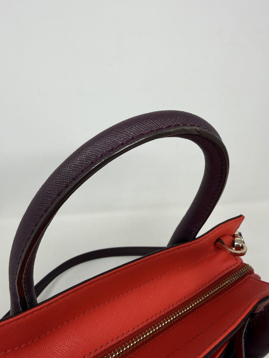 Kate Spade New York Small Cameron Saffiano leather satchel in burgundy and red with top handles and gold hardware.