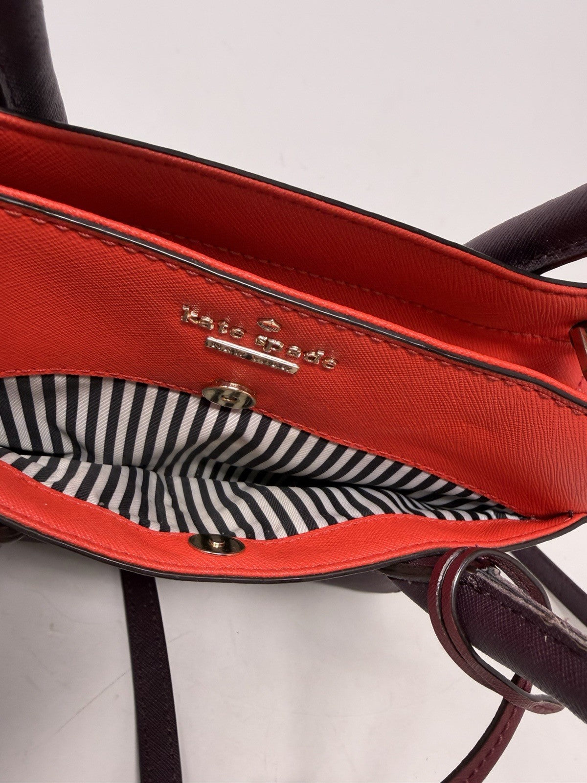 Kate Spade New York Small Cameron Saffiano leather satchel in burgundy and red with gold hardware, pre-owned and stylish.