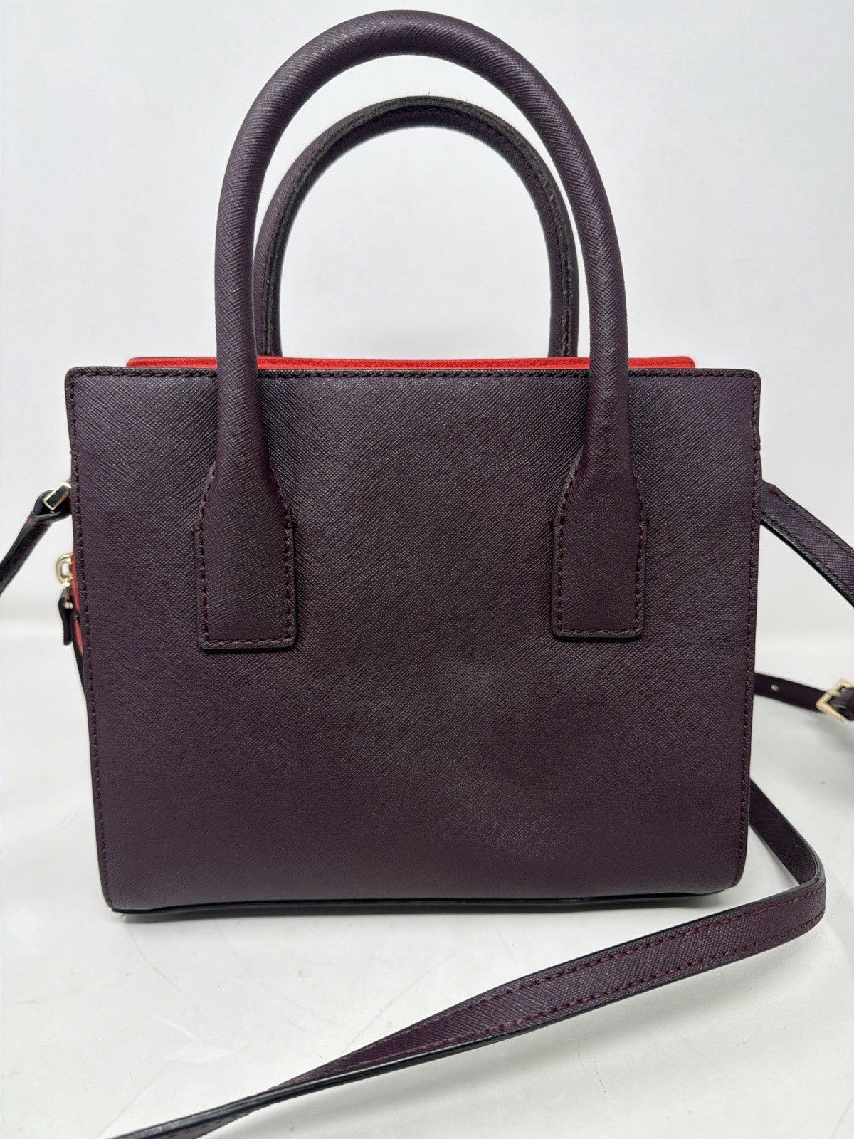 Kate Spade New York Small Cameron Saffiano leather satchel in burgundy and red, featuring a structured design with top handles.