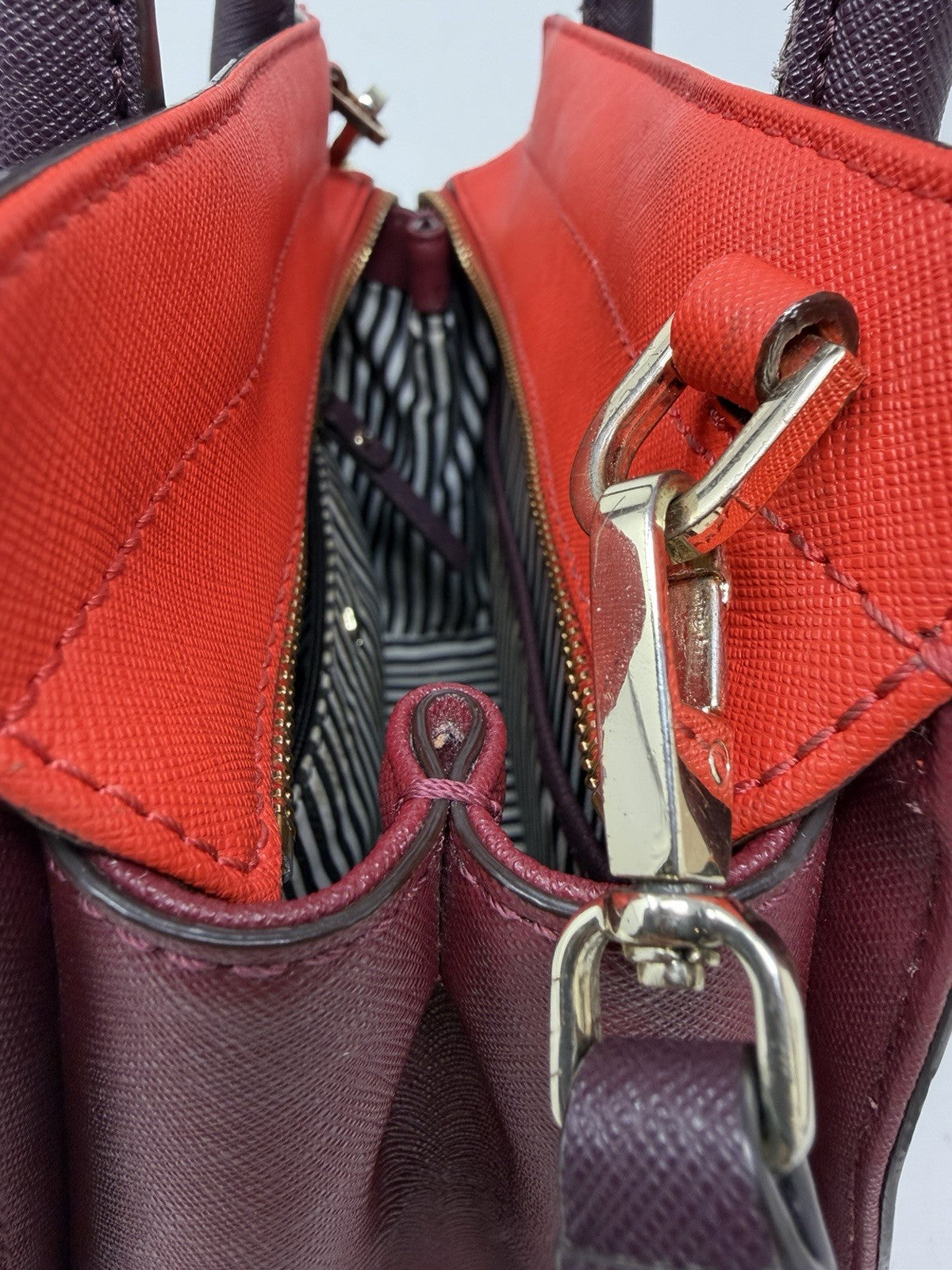 Kate Spade New York Small Cameron Saffiano leather satchel in burgundy and red, featuring gold hardware and top handle.