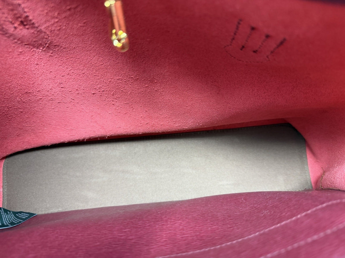 Red lining and gold-tone fittings inside the City Tote