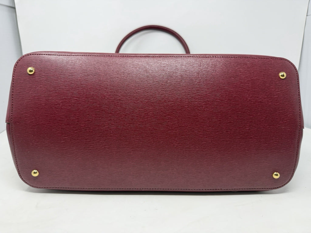 Base of the rosewood City Tote with gold-tone protective feet