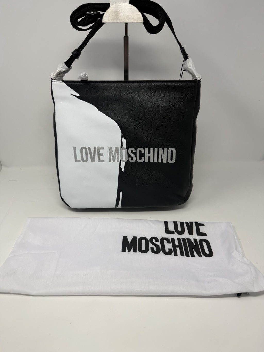 Love Moschino black and white saffiano-effect logo shoulder bag, front view with dust bag