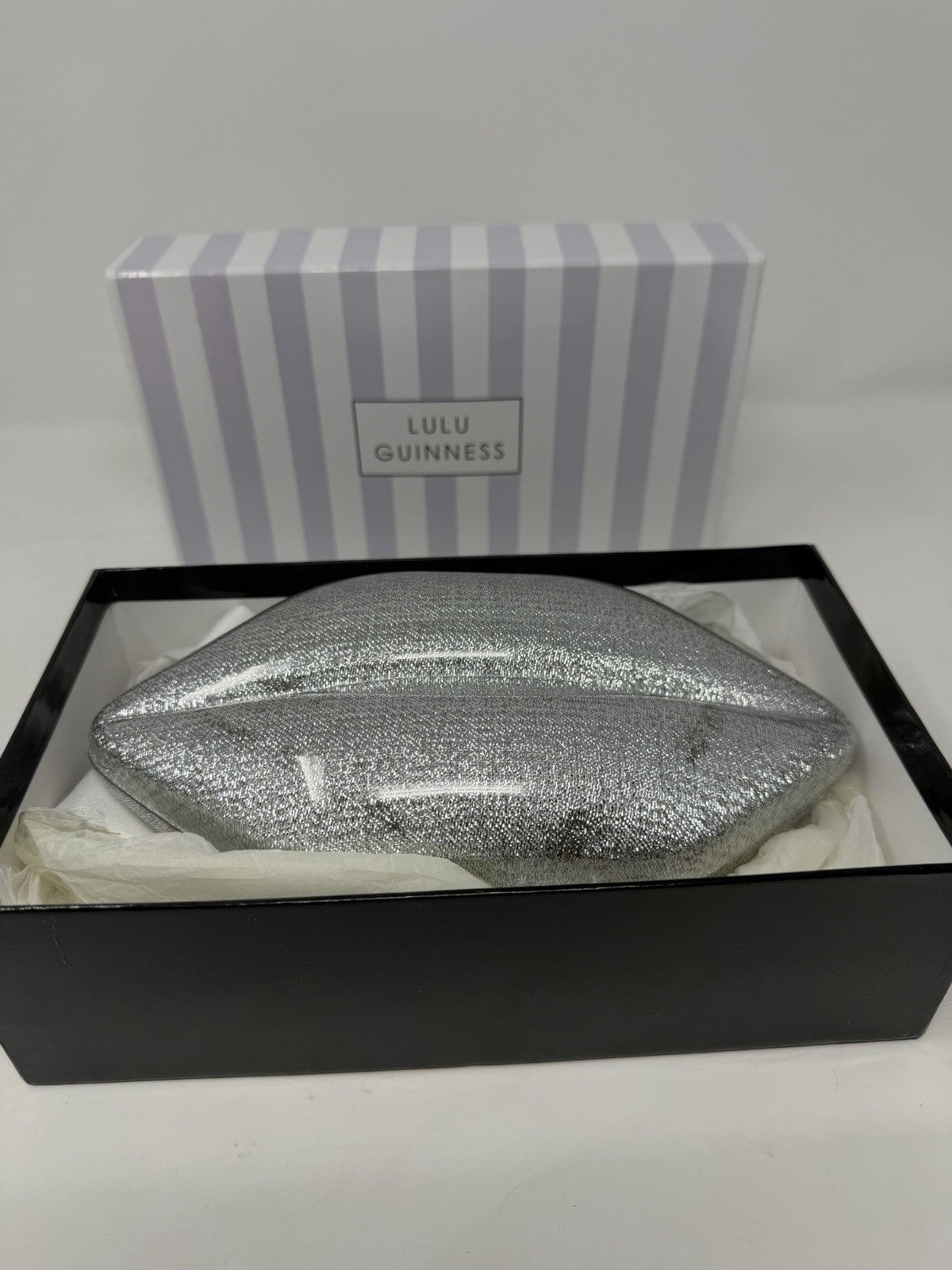 Lulu Guinness silver Perspex Lip Clutch, clutch sitting in its open box