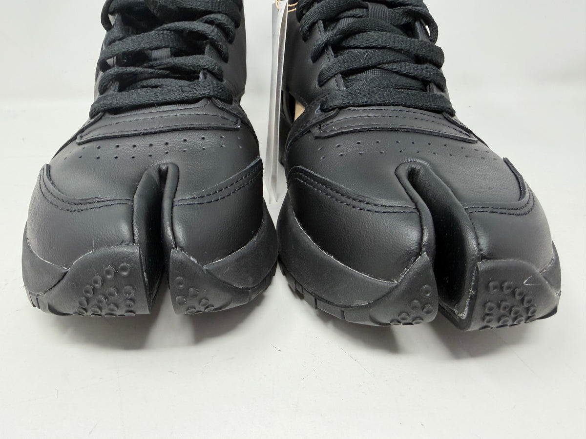 Maison Margiela × Reebok Classic Leather Tabi High black trainers, UK 6.5, featuring sleek leather design and distinctive split-toe detail.