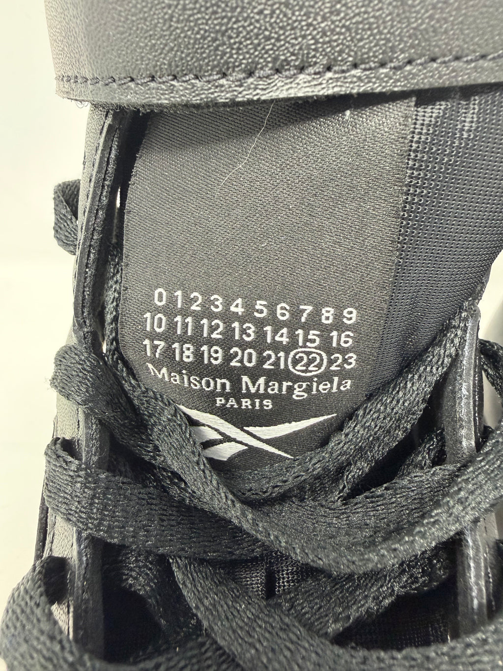 Maison Margiela × Reebok Classic Leather Tabi High black trainers, UK 6.5, with distinctive split-toe design and sleek leather finish.