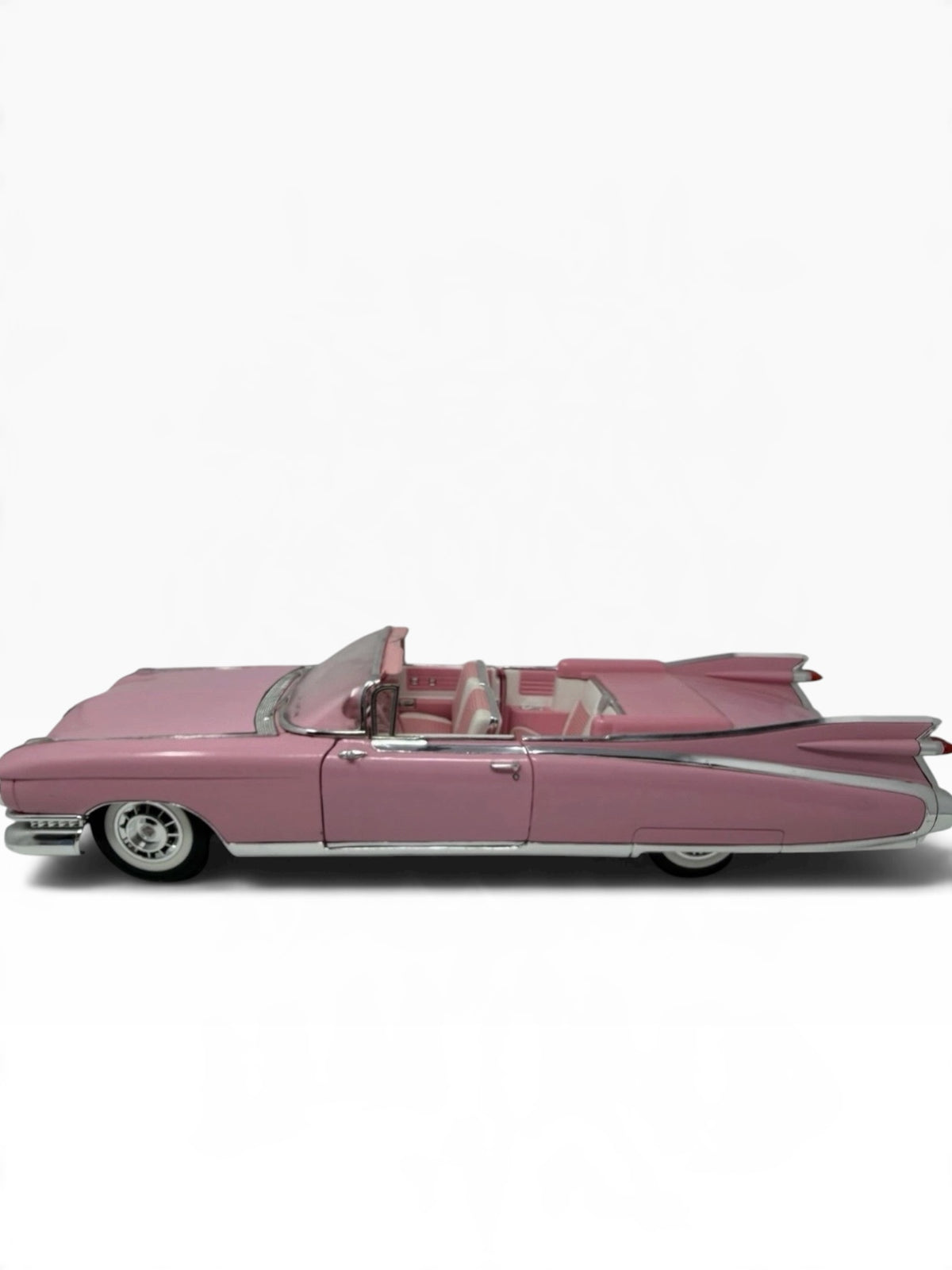Pink Maisto 1959 Cadillac Eldorado Biarritz diecast convertible model, detailed collectible toy in 1:12 scale.