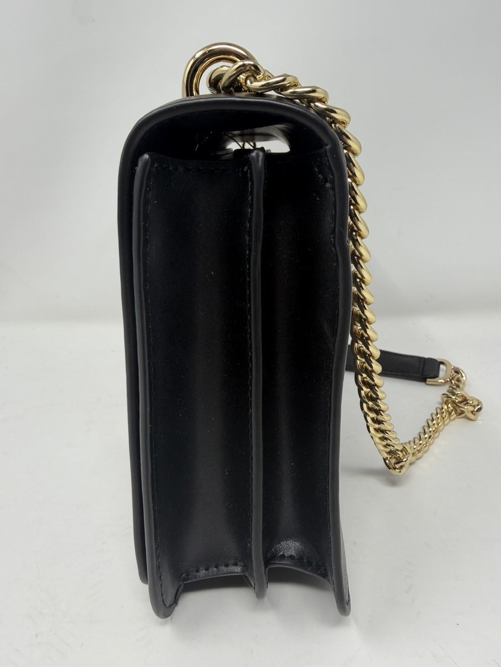 Michael Kors Mott large chain shoulder bag in black leather, side profile with chain