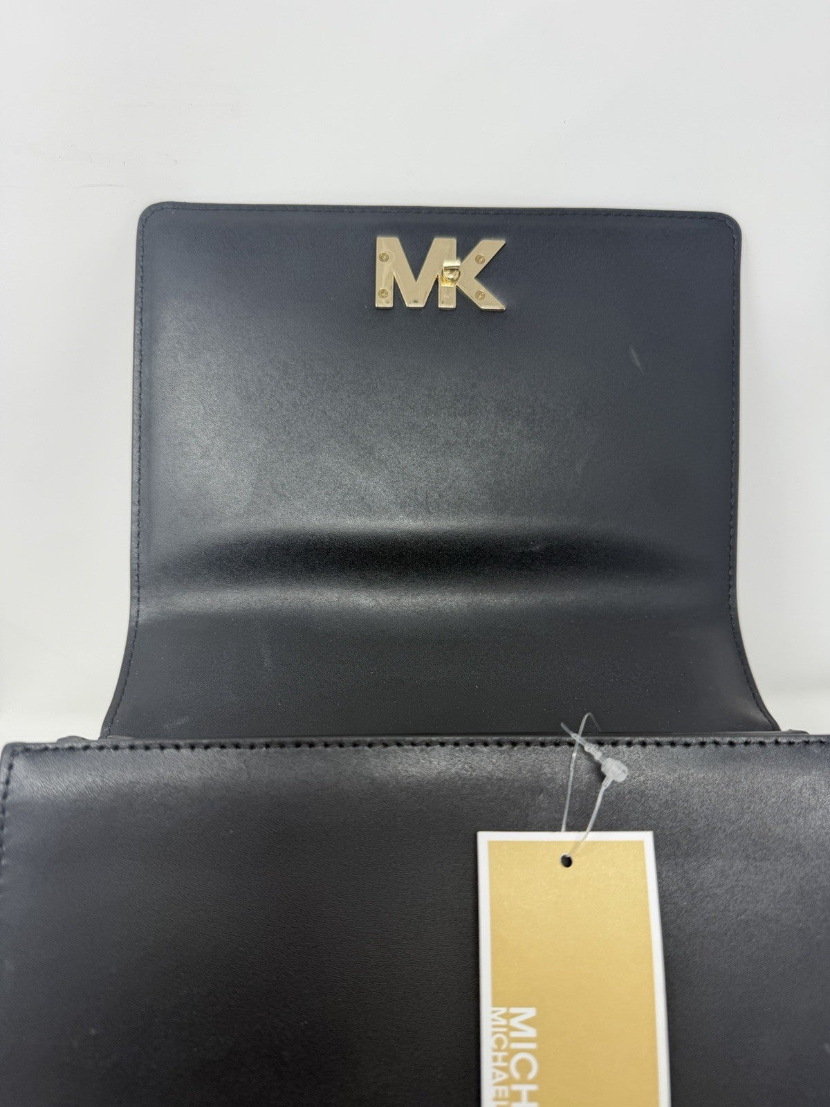 Michael Kors Mott large chain shoulder bag in black leather, flap open with swing tag