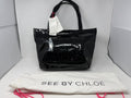 See By Chloé large black patent logo tote shopper with spacious interior, handles, dust bag, and included card.