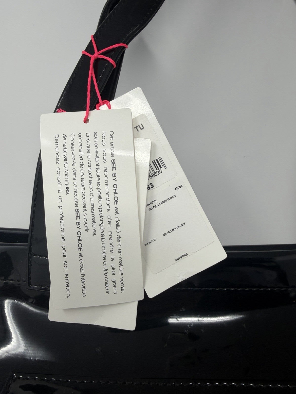 See By Chloé large black patent logo tote shopper with dust bag and card, showing spacious interior and stylish design.