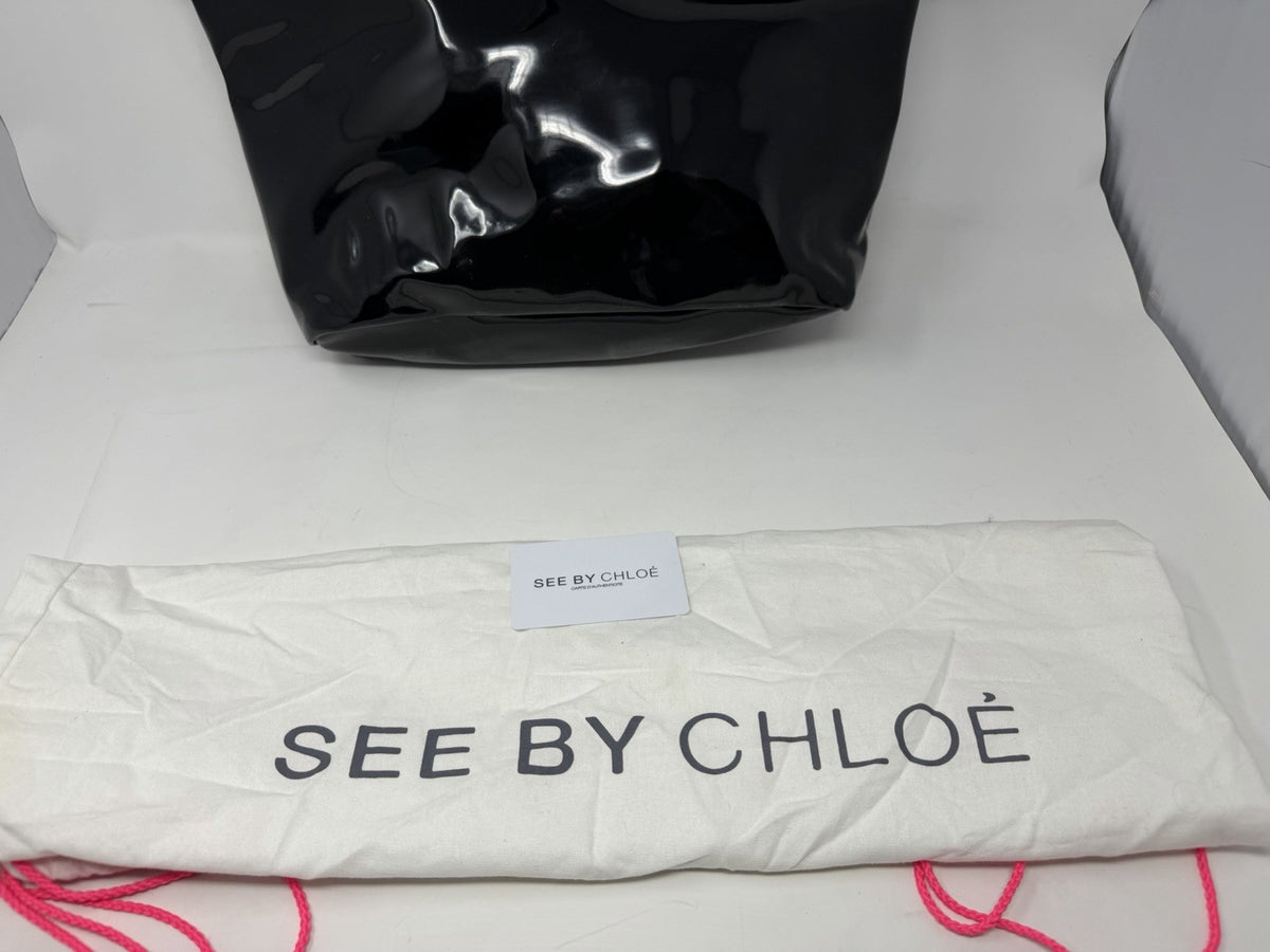 See By Chloé large black patent logo tote shopper with dust bag and card, featuring sturdy handles and spacious interior.