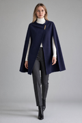 Ted Baker Vickiye navy wool and cashmere cape worn by a model, asymmetric wrap front with gold-tone bar